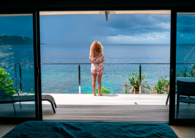 Woman on balcony of swell lodge in the wet season on Christmas Island